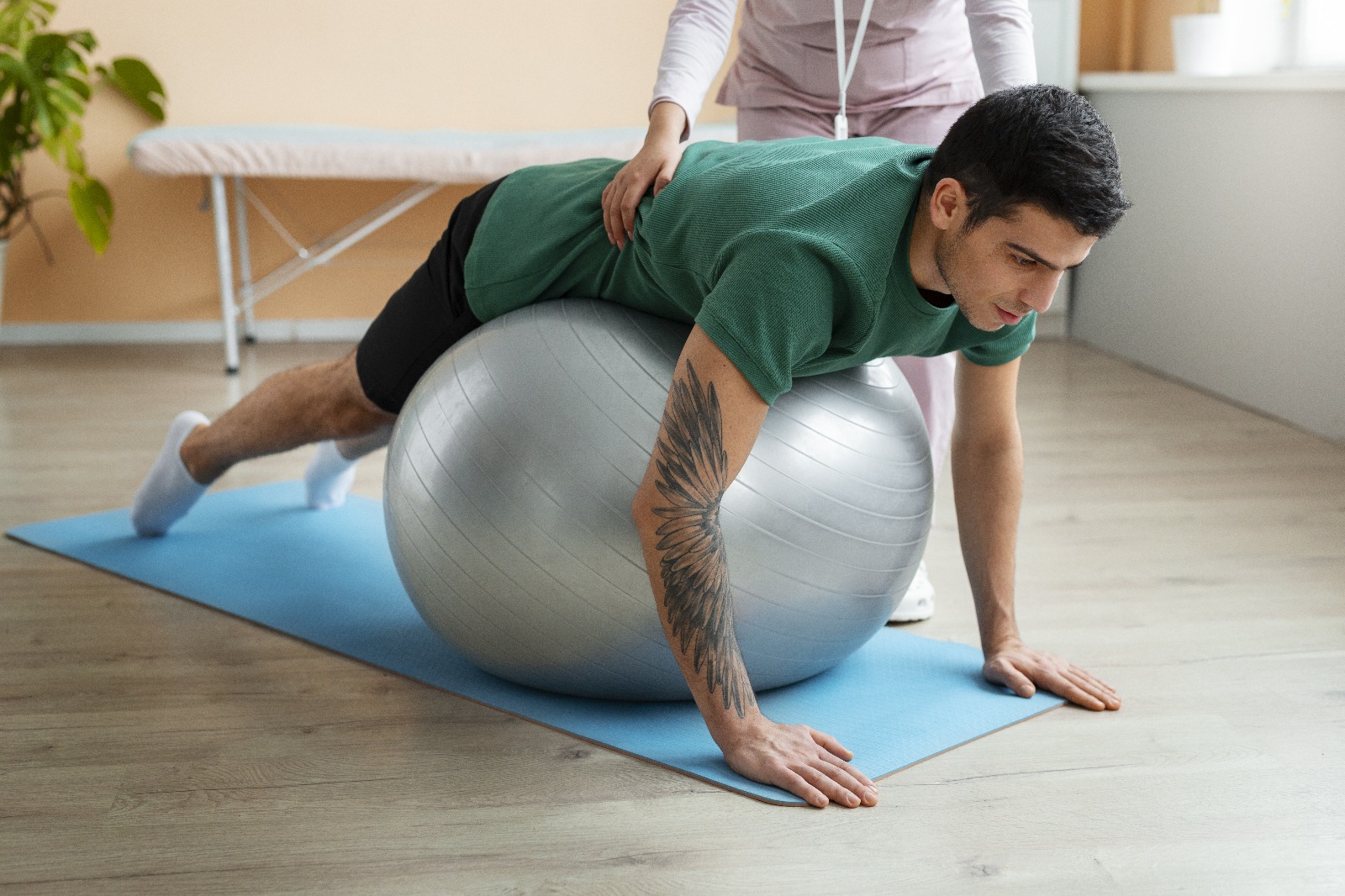 Physical therapist guiding a patient through a movement exercise